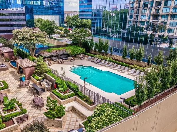 a view of the patio with couches chairs and a fire pit