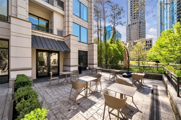 a view of a patio with couches table and chairs and potted plants