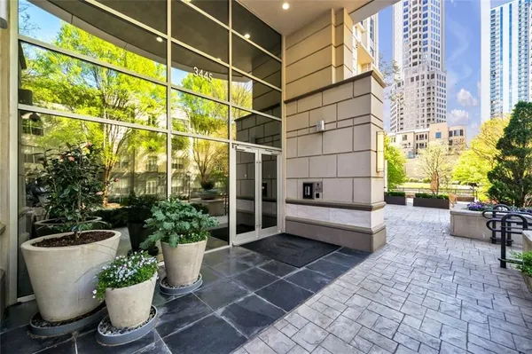 a view of a building with sitting area and a garden