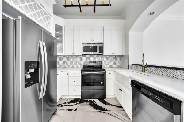 a kitchen with a stove and a refrigerator