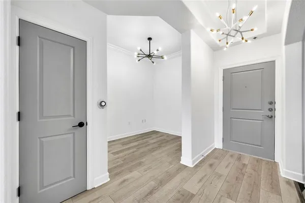 a view of a room with wooden floor and a ceiling fan