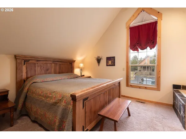 a bedroom with a bed and window