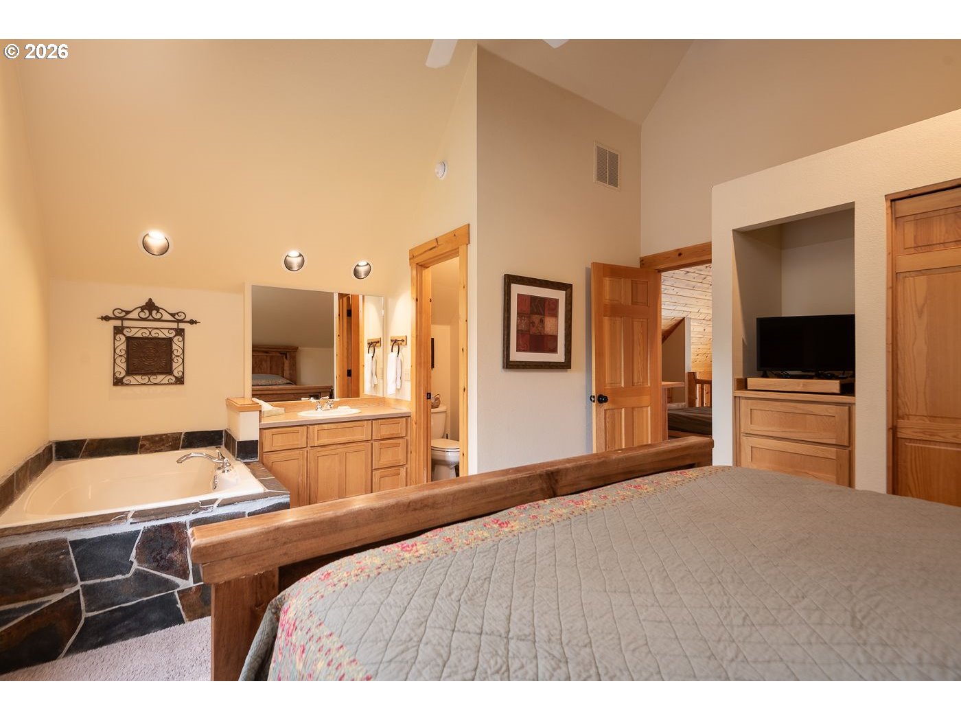 8968 Cliff Swallow Drive Redmond, OR 97756 - Photo 12 of 25 a bedroom with a bed and a view of kitchen