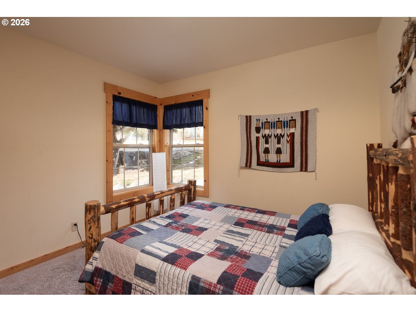 8968 Cliff Swallow Drive Redmond, OR 97756 - Photo 16 of 25 a bedroom with a bed and a window