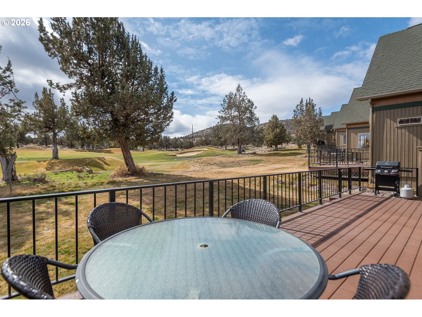 8968 Cliff Swallow Drive Redmond, OR 97756 - Photo 22 of 25 a balcony with table and chairs