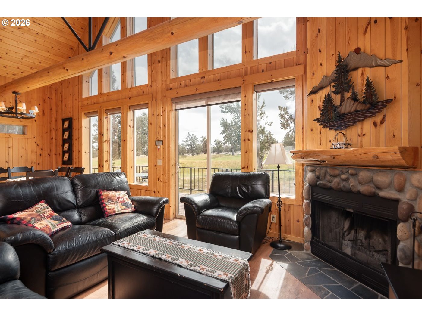 8968 Cliff Swallow Drive Redmond, OR 97756 - Photo 5 of 25 a living room with furniture a large window and a fireplace