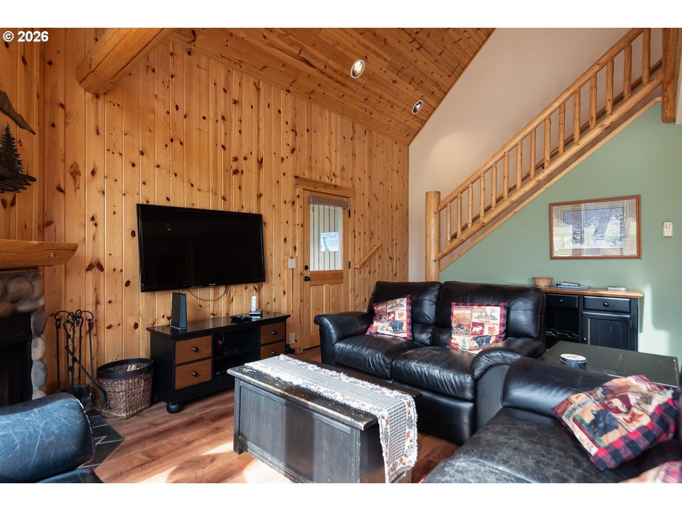 8968 Cliff Swallow Drive Redmond, OR 97756 - Photo 10 of 25 a living room with furniture a flat screen tv and a fireplace