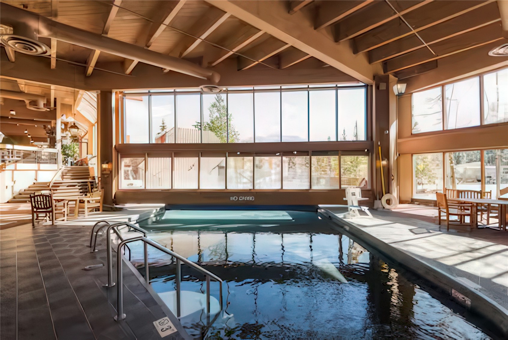 611 Village Road, Unit 21240 Breckenridge, CO 80424 - Photo 15 of 23 a dining room with furniture a chandelier and wooden floor