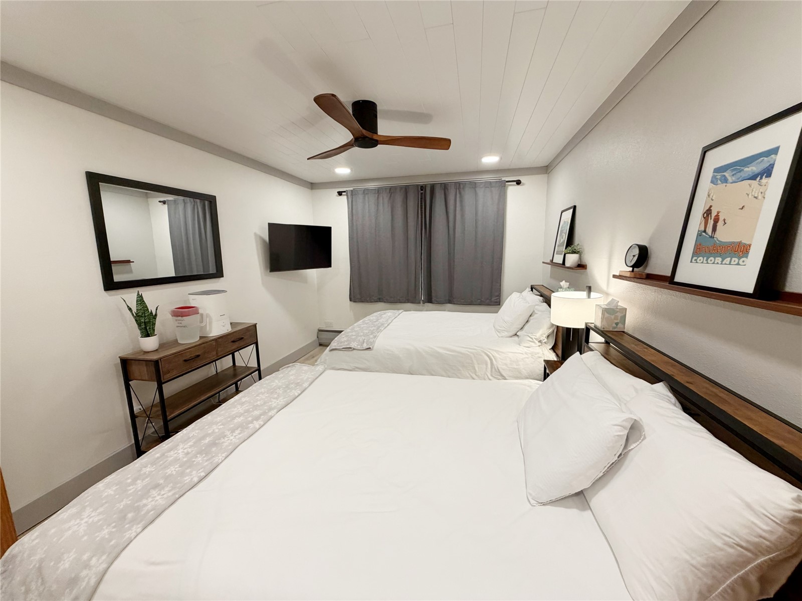 611 Village Road, Unit 21240 Breckenridge, CO 80424 - Photo 7 of 23 a bedroom with a bed and a flat screen tv