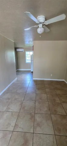 an empty room with a empty space and windows