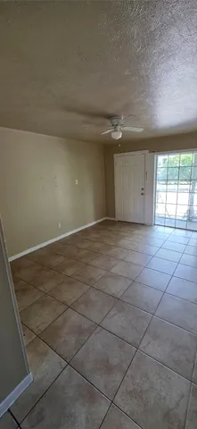 a kitchen with a refrigerator and a stove top oven