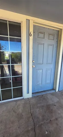 a view of a livingroom with a ceiling fan and entryway