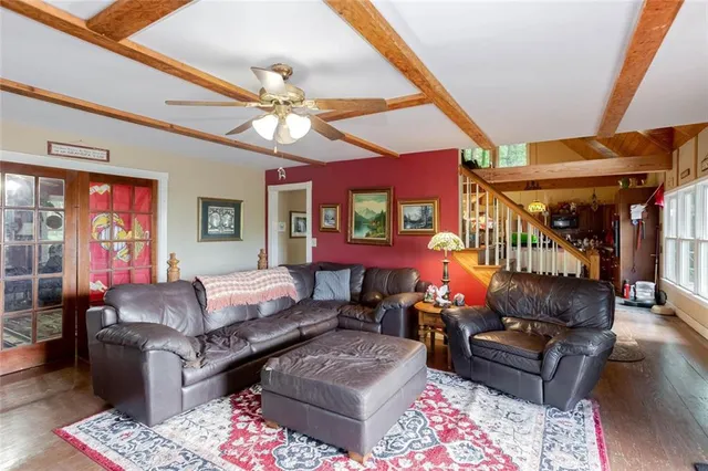 a living room with furniture a fireplace and a chandelier