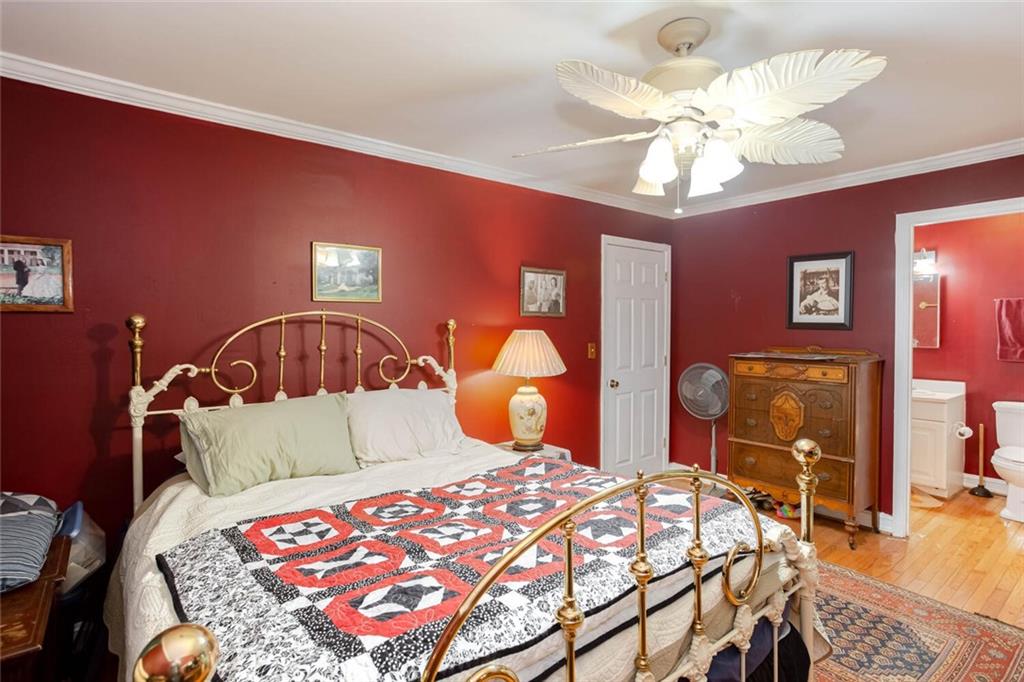 8 Mt Sequoyah Road Jasper, GA 30143 - Photo 31 of 86 a bedroom with a bed a chandelier and dresser