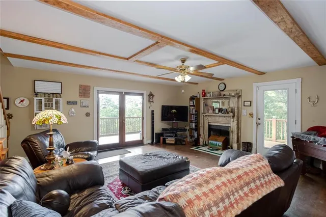 a living room with furniture fireplace and a large window