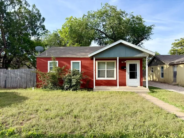 a front view of a house with yard and green space