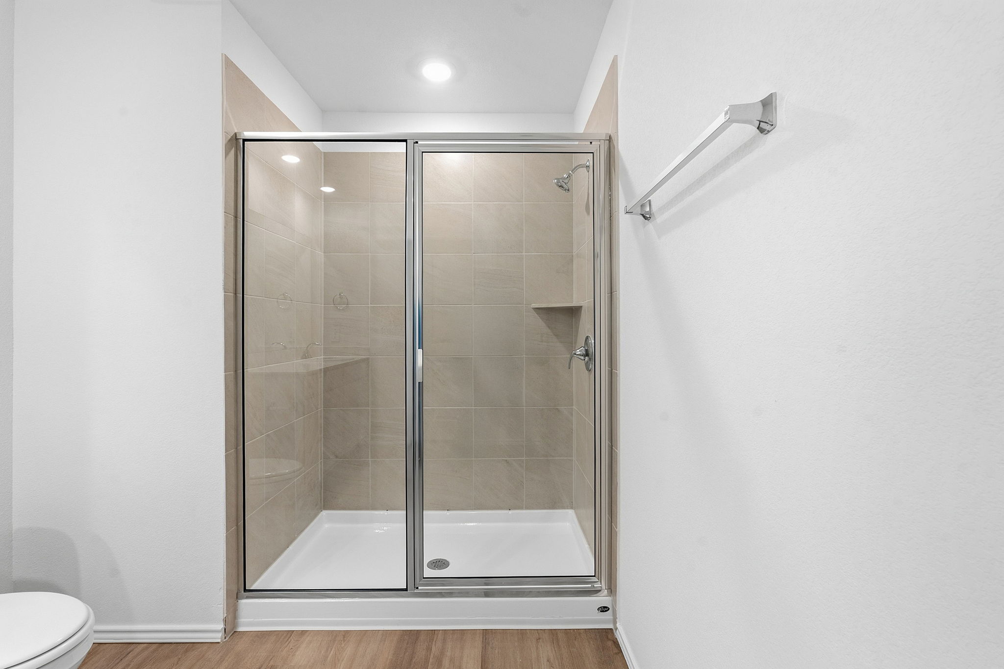 164 Cinnabar Lane, Unit 2 Kyle, TX 78640 - Photo 14 of 21 Glass-enclosed shower with tile surround, built-in shelving, white shower pan, and chrome fixtures