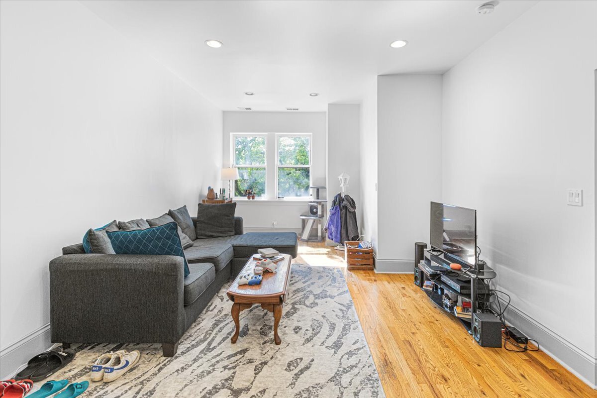 4855 North Springfield Avenue, Unit 3 Chicago, IL 60625 - Photo 2 of 9 a living room with furniture and a flat screen tv