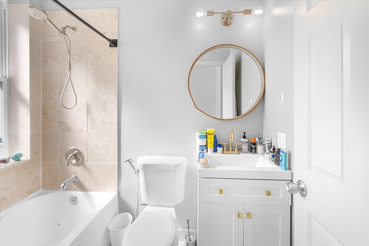 4855 North Springfield Avenue, Unit 3 Chicago, IL 60625 - Photo 6 of 9 a bathroom with a sink toilet and a bathtub