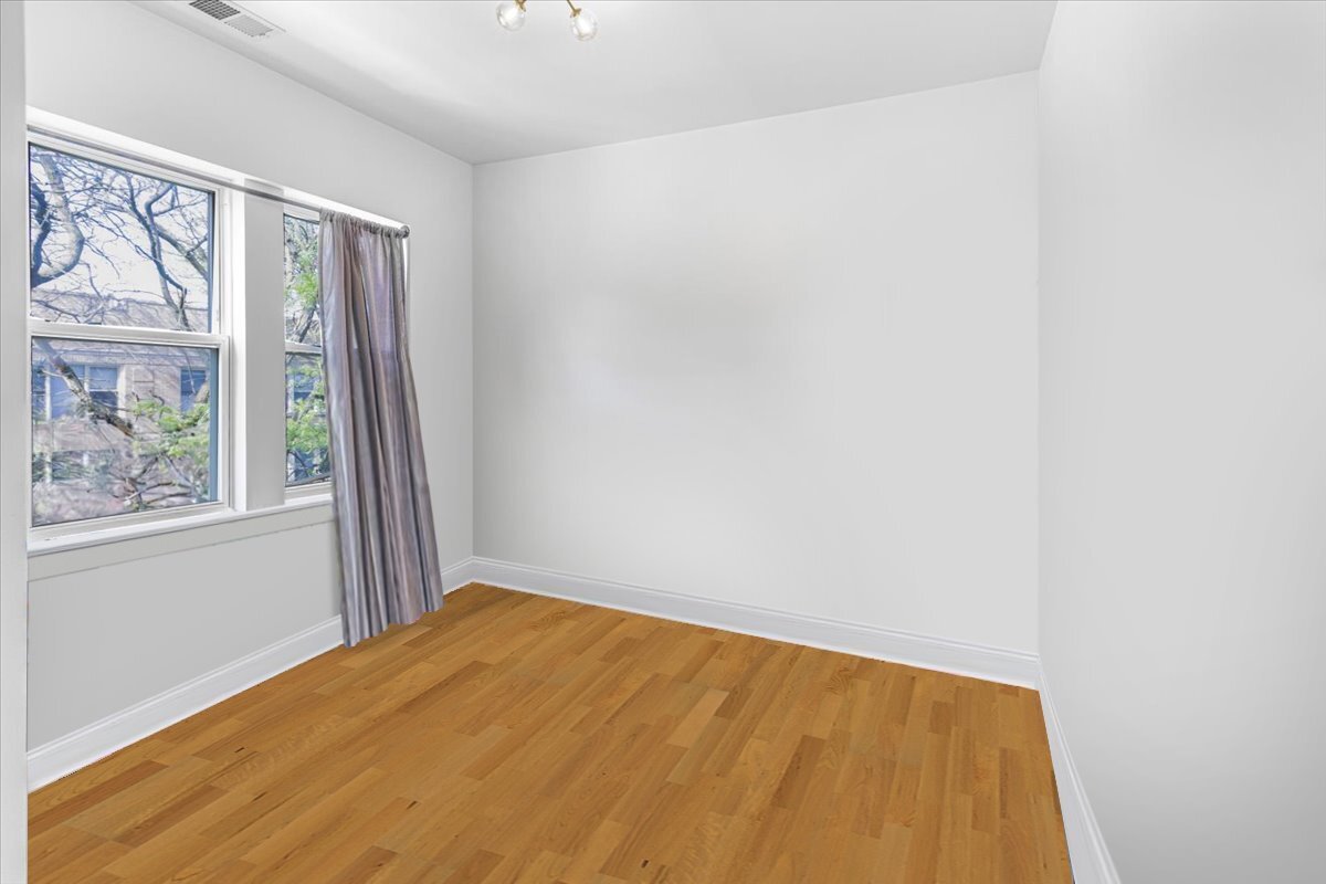 4855 North Springfield Avenue, Unit 3 Chicago, IL 60625 - Photo 7 of 9 a view of an empty room with a window