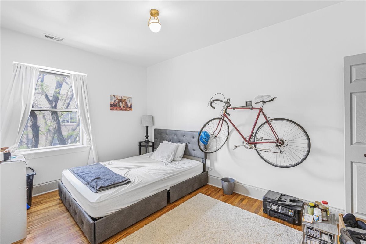 4855 North Springfield Avenue, Unit 3 Chicago, IL 60625 - Photo 8 of 9 a bedroom with furniture and a window