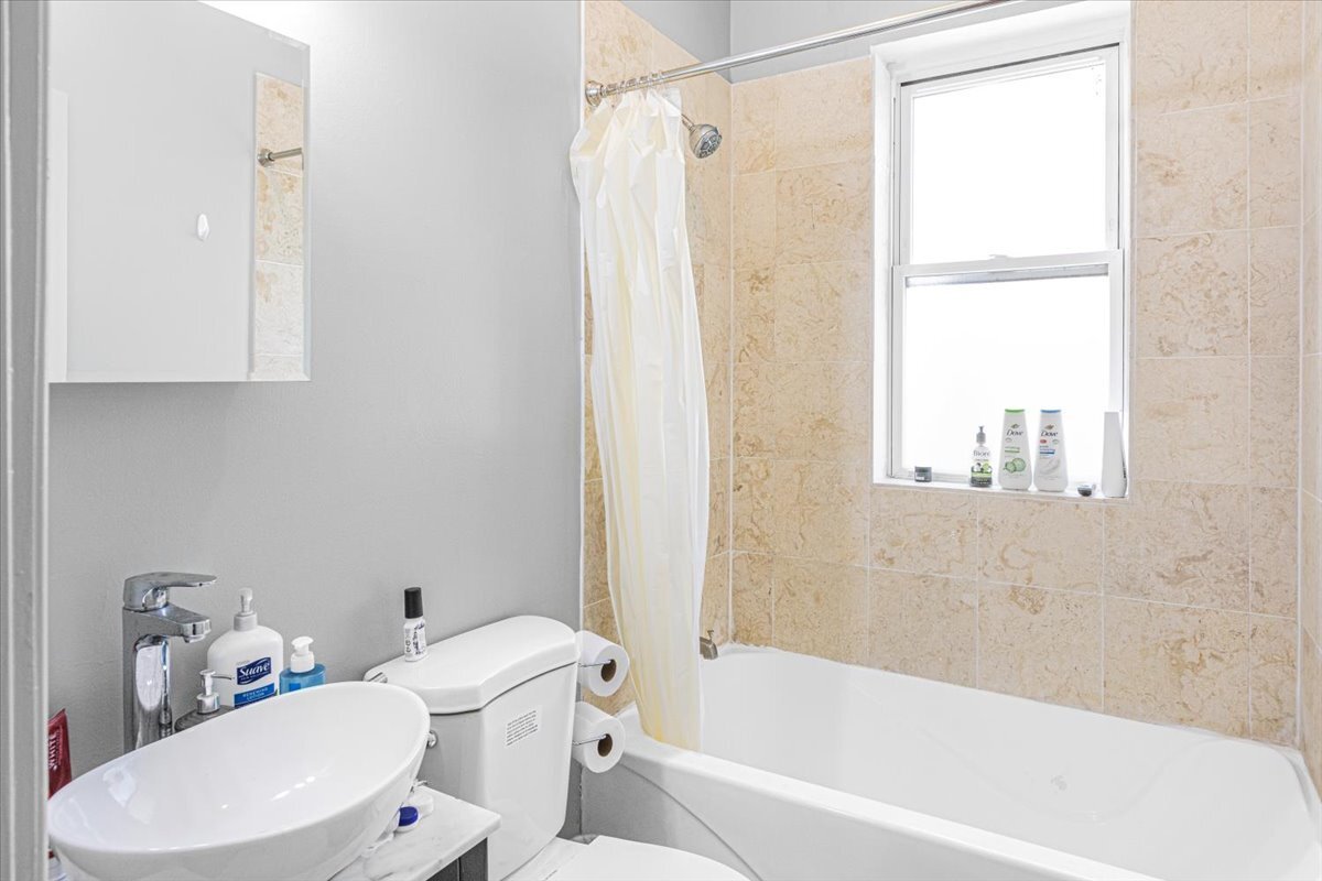 4855 North Springfield Avenue, Unit 3 Chicago, IL 60625 - Photo 9 of 9 a bathroom with a sink toilet and shower