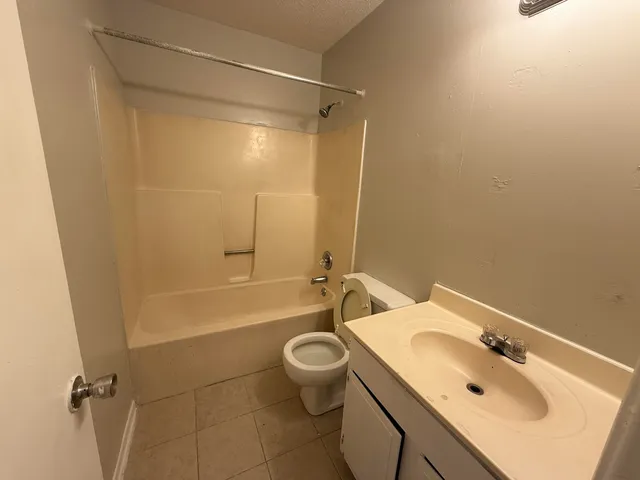 a bathroom with a sink mirror toilet and bathtub