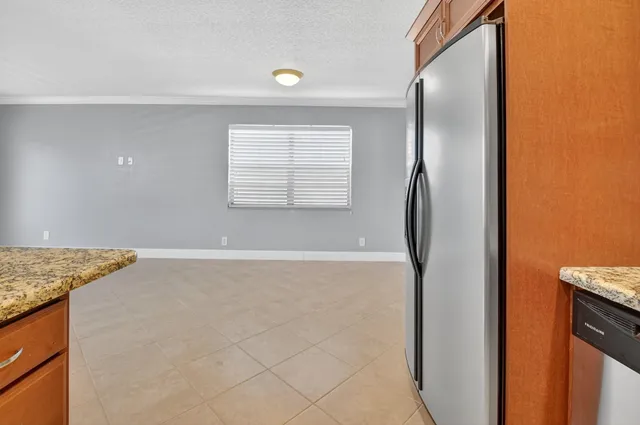 a bathroom with a granite countertop sink a toilet and a mirror