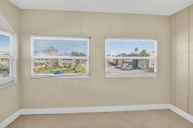 a view of a patio with table and chairs under an umbrella