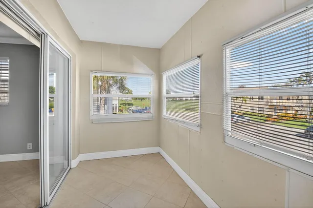 a view of a swimming pool with a patio and a yard