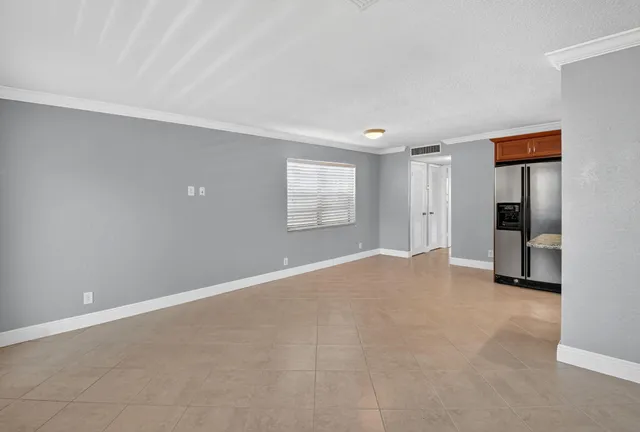 a kitchen with granite countertop wooden cabinets stainless steel appliances and a sink