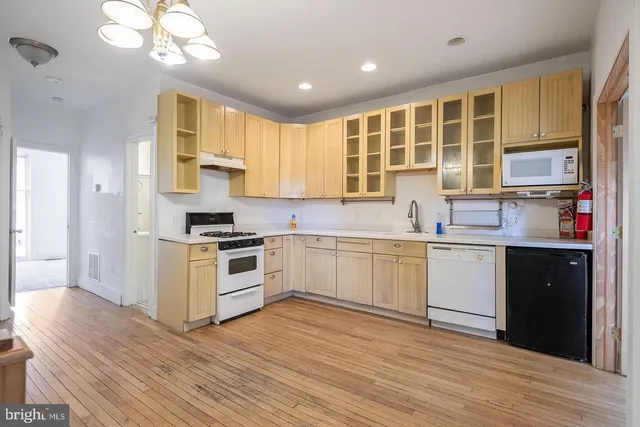 a kitchen with a sink window and cabinets