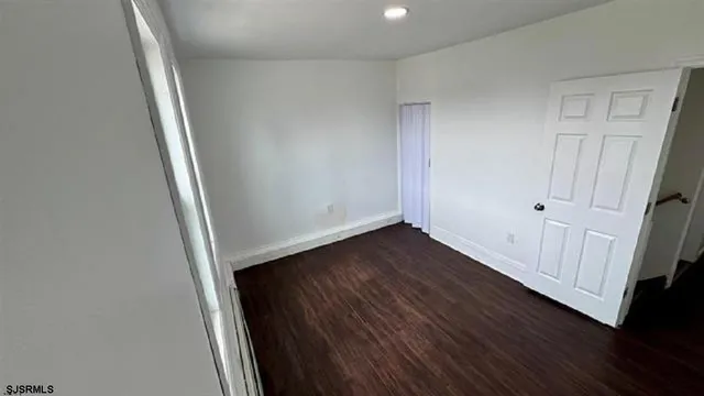 a view of room with wooden floor