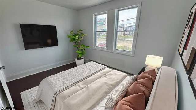 a bedroom with a bed and a flat screen tv