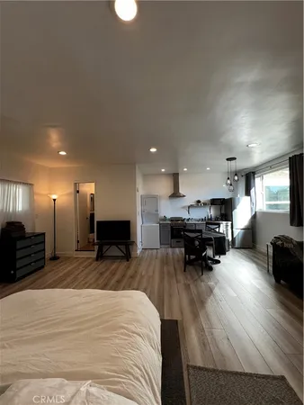 a kitchen with furniture and a wooden floor