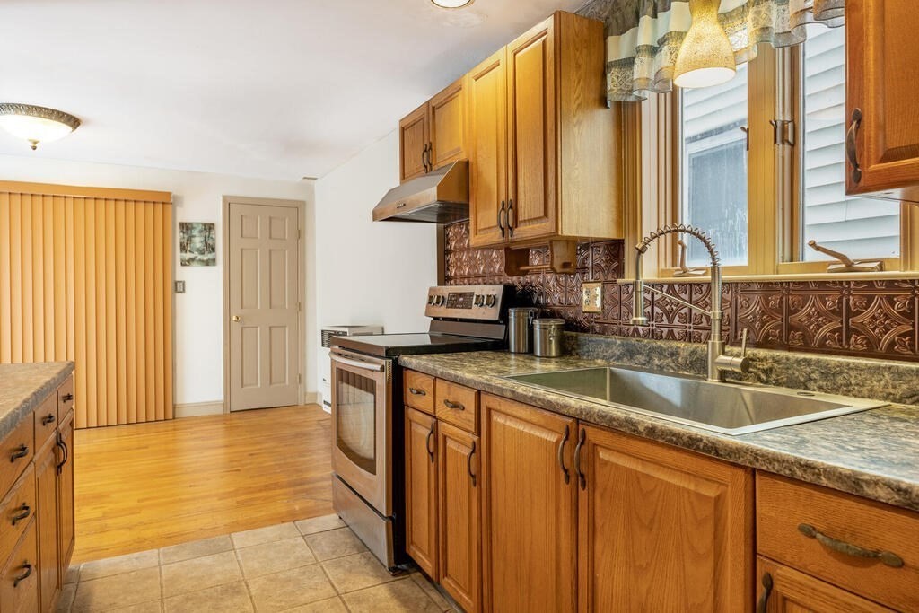 9 Cross Street Somerville, MA 02145 - Photo 11 of 18 a kitchen with a sink and a refrigerator