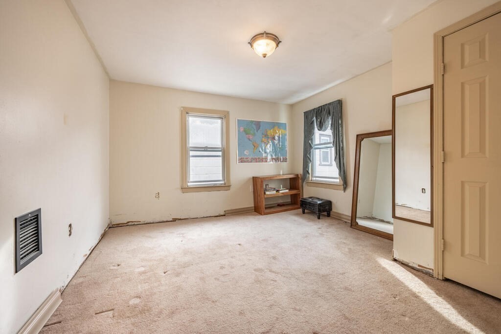 9 Cross Street Somerville, MA 02145 - Photo 14 of 18 a view of a livingroom with furniture and a window