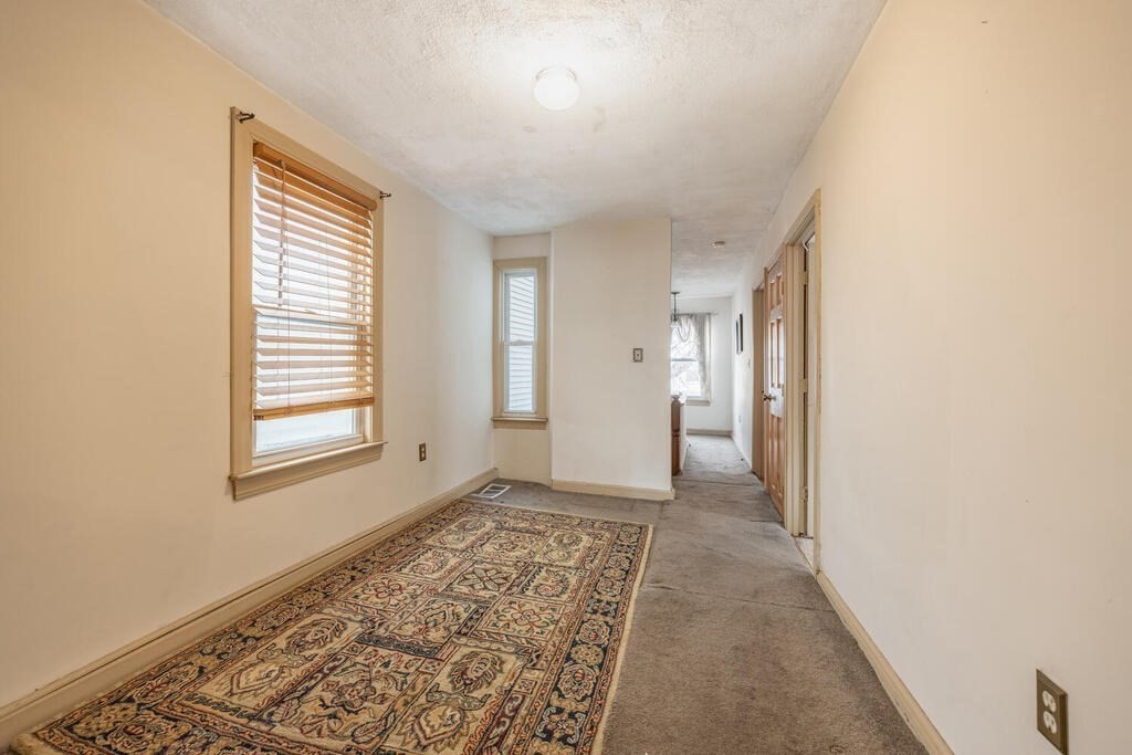 9 Cross Street Somerville, MA 02145 - Photo 15 of 18 a view of an empty room and window