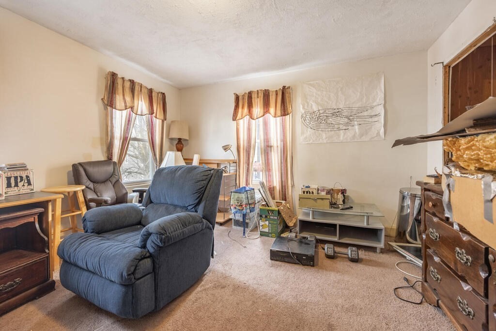 9 Cross Street Somerville, MA 02145 - Photo 16 of 18 a living room with furniture and a window