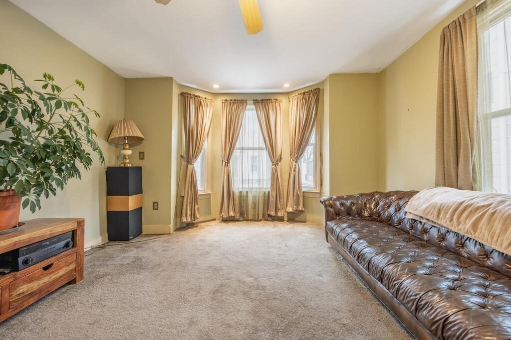 9 Cross Street Somerville, MA 02145 - Photo 3 of 18 a spacious bedroom with a bed and a window