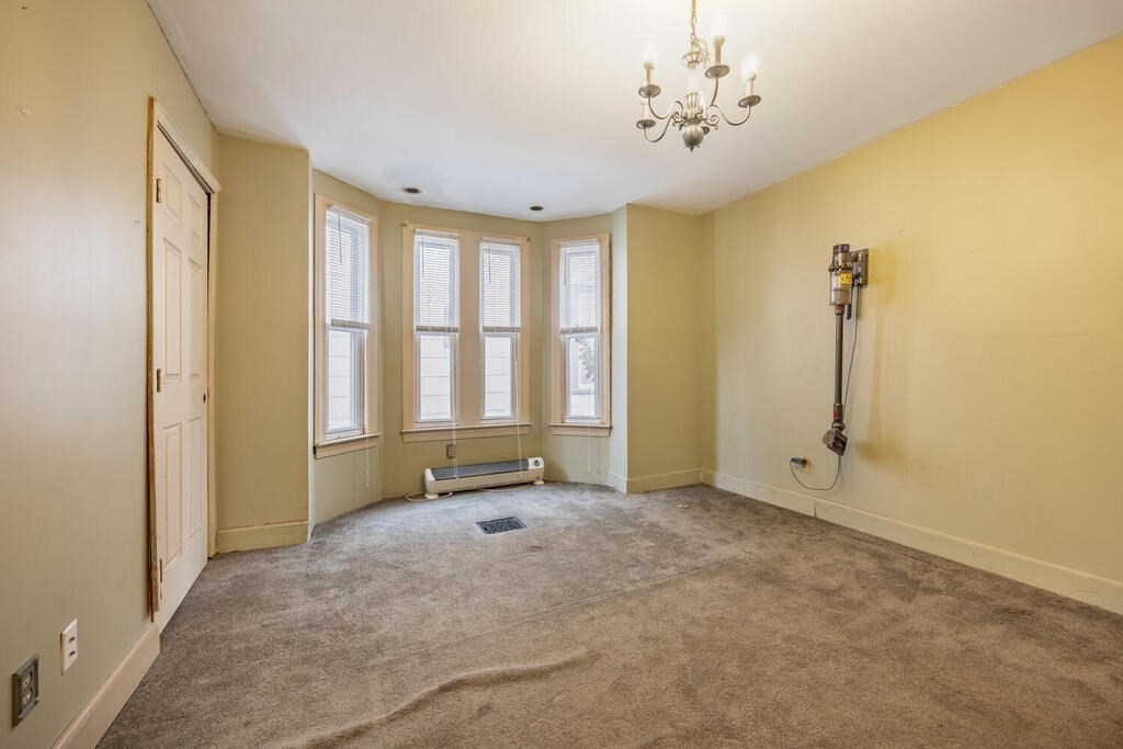 9 Cross Street Somerville, MA 02145 - Photo 5 of 18 a view of an empty room with a window