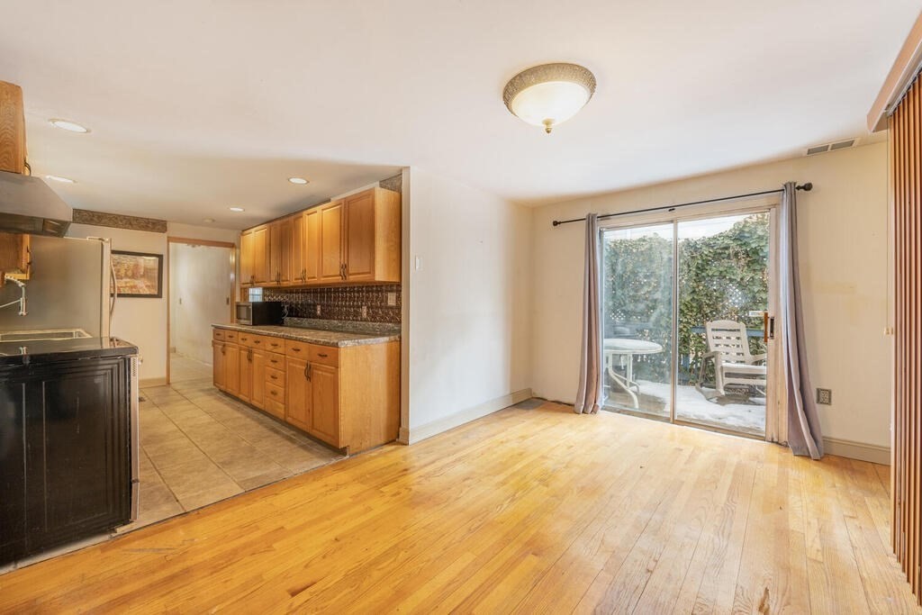 9 Cross Street Somerville, MA 02145 - Photo 9 of 18 a kitchen with stainless steel appliances granite countertop a stove and a refrigerator