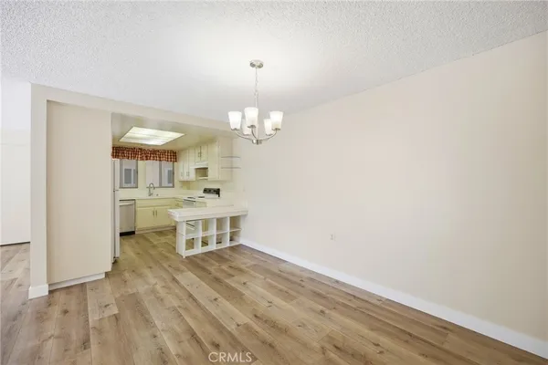 a room with a white cabinets and chandelier