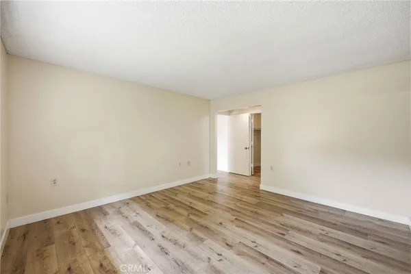 a view of an empty room and wooden floor