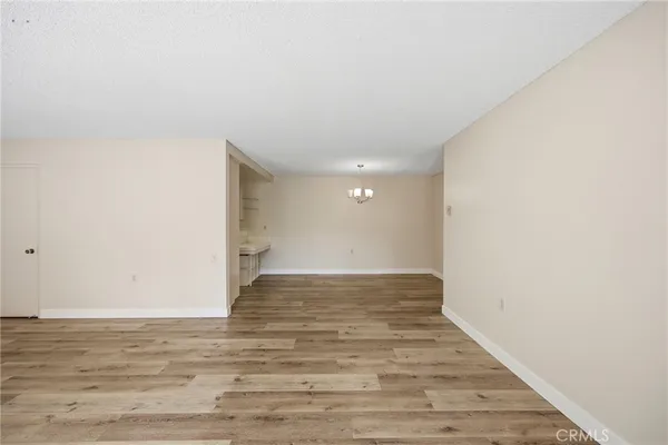 a view of an empty room and wooden floor