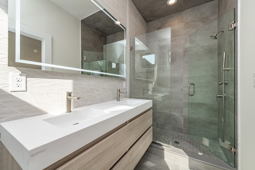 116 School Street, Unit 2 Boston, MA 02119 - Photo 12 of 24 a bathroom with a sink and a mirror