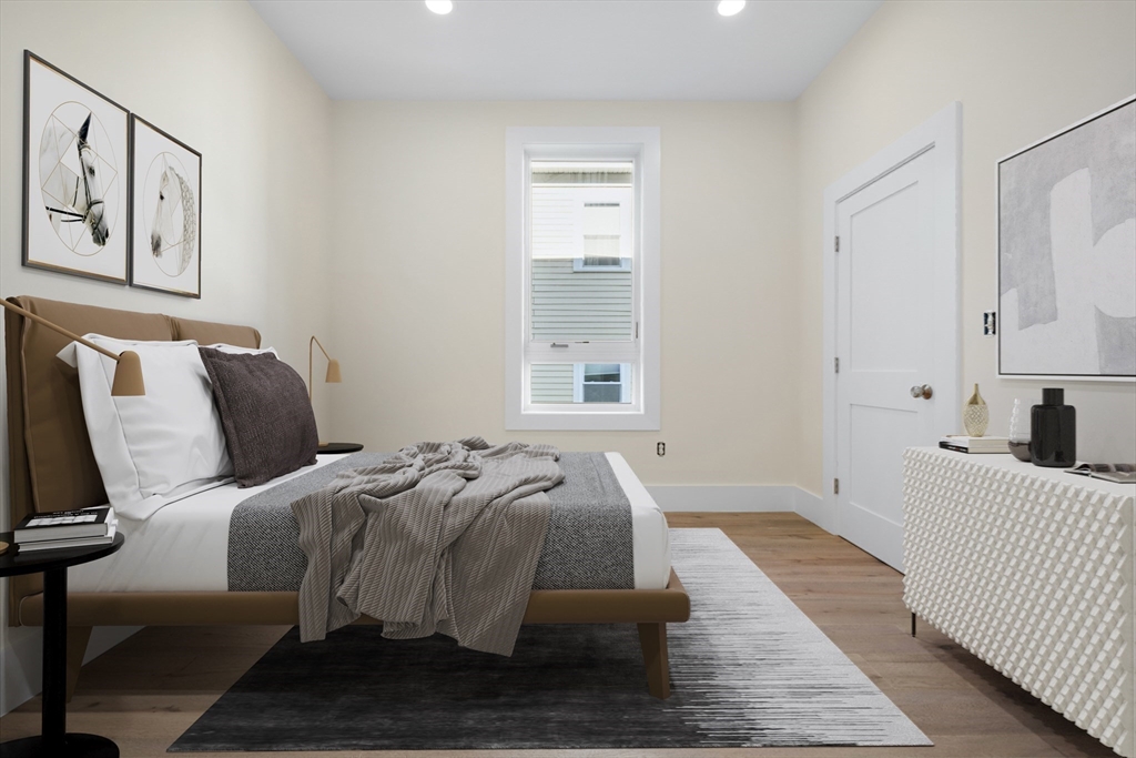 116 School Street, Unit 2 Boston, MA 02119 - Photo 14 of 24 a bed room with a bed and a couch