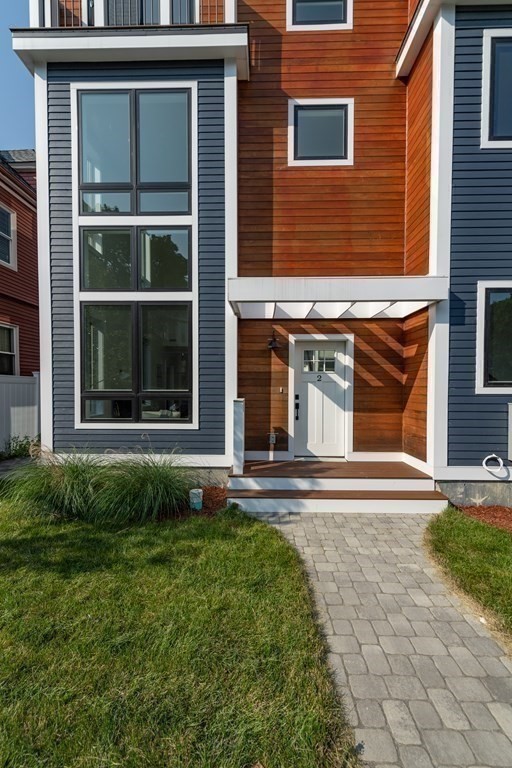 116 School Street, Unit 2 Boston, MA 02119 - Photo 17 of 24 a front view of a house with a yard