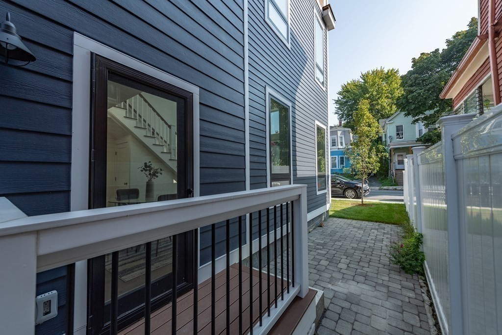 116 School Street, Unit 2 Boston, MA 02119 - Photo 18 of 24 a view of a house with a yard