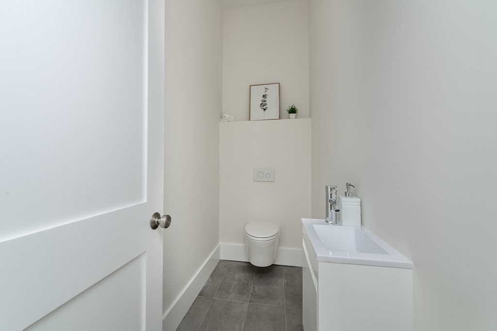 116 School Street, Unit 2 Boston, MA 02119 - Photo 19 of 24 a bathroom with a sink and toilet